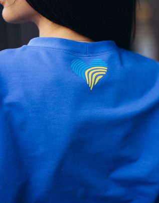 Woman in blue sports wear standing outside by the building